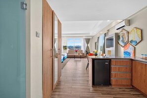 A modern kitchen with a built-in refrigerator, wooden cabinets, and a dining area with a view. - PrideInn Plaza Nairobi Airport (Mlolongo)
