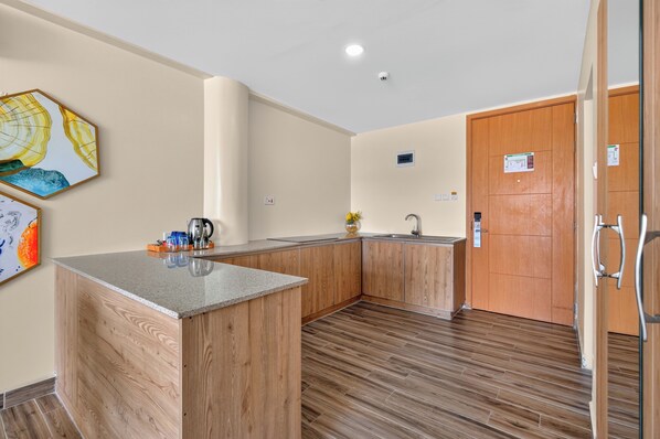 A modern kitchen with wooden cabinets, a granite countertop, and a built-in sink.