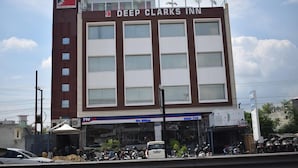 A multi-story building with a sign reading "Deep Clark's Inn." - Hotel Deep Clarks Inn Lucknow  (Lucknow)