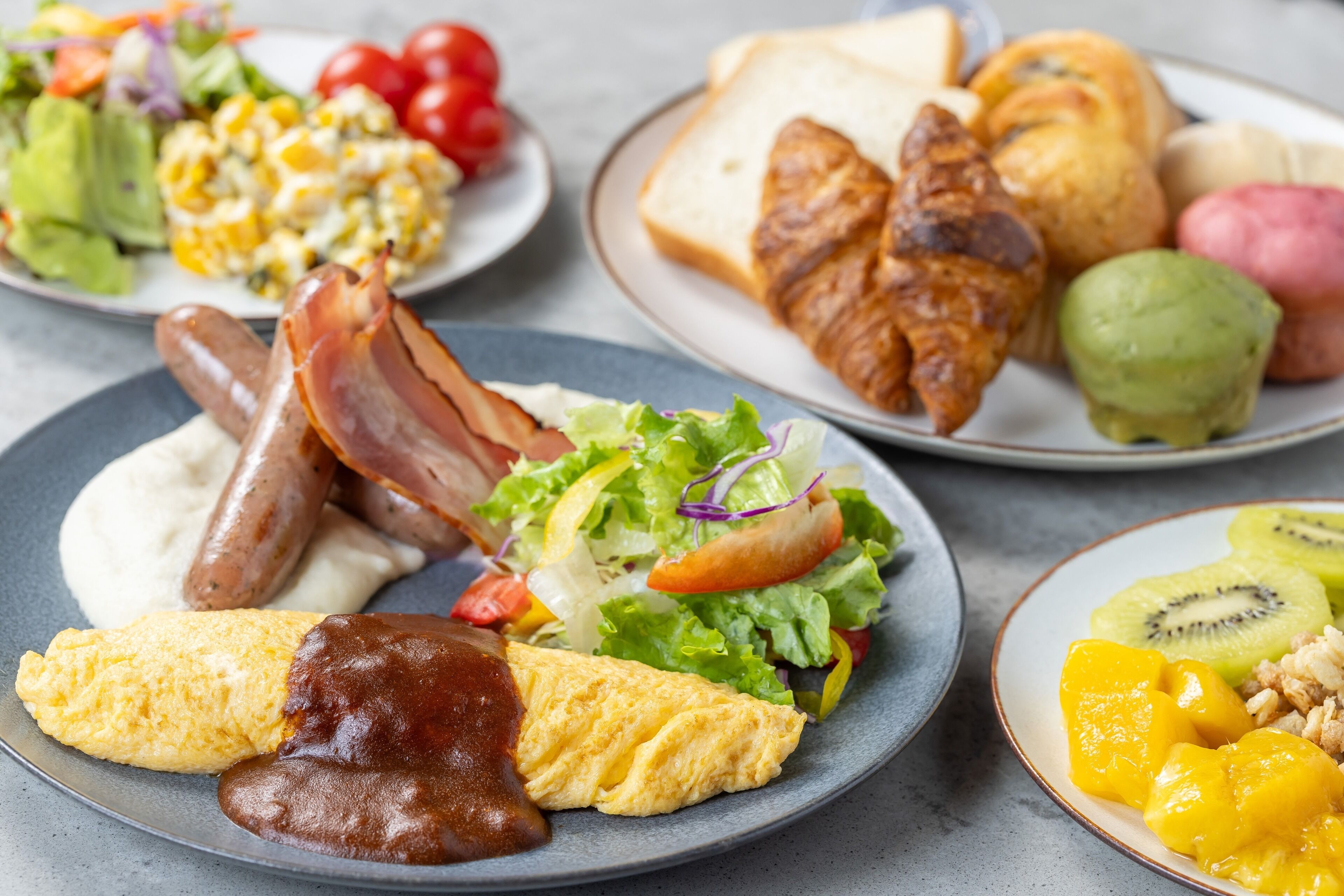 A breakfast spread with various dishes including eggs, bacon, toast, and fruit.