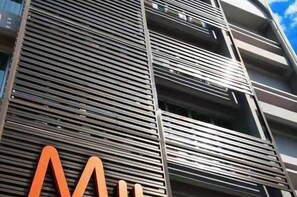 A modern building with a series of horizontal lines and balconies. - MII Smile Hotel (George Town)