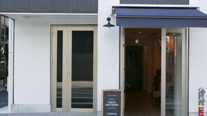 The entrance to a hotel with a signboard displaying the name and location. - Tokyo Sakurako Hatchobori (Tokyo)