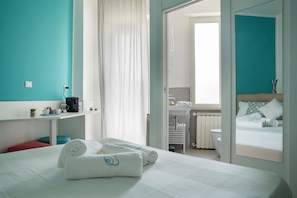 A hotel room with a bed, a bathroom, and a view of the outside. - Dimora Chloe (Pescara)