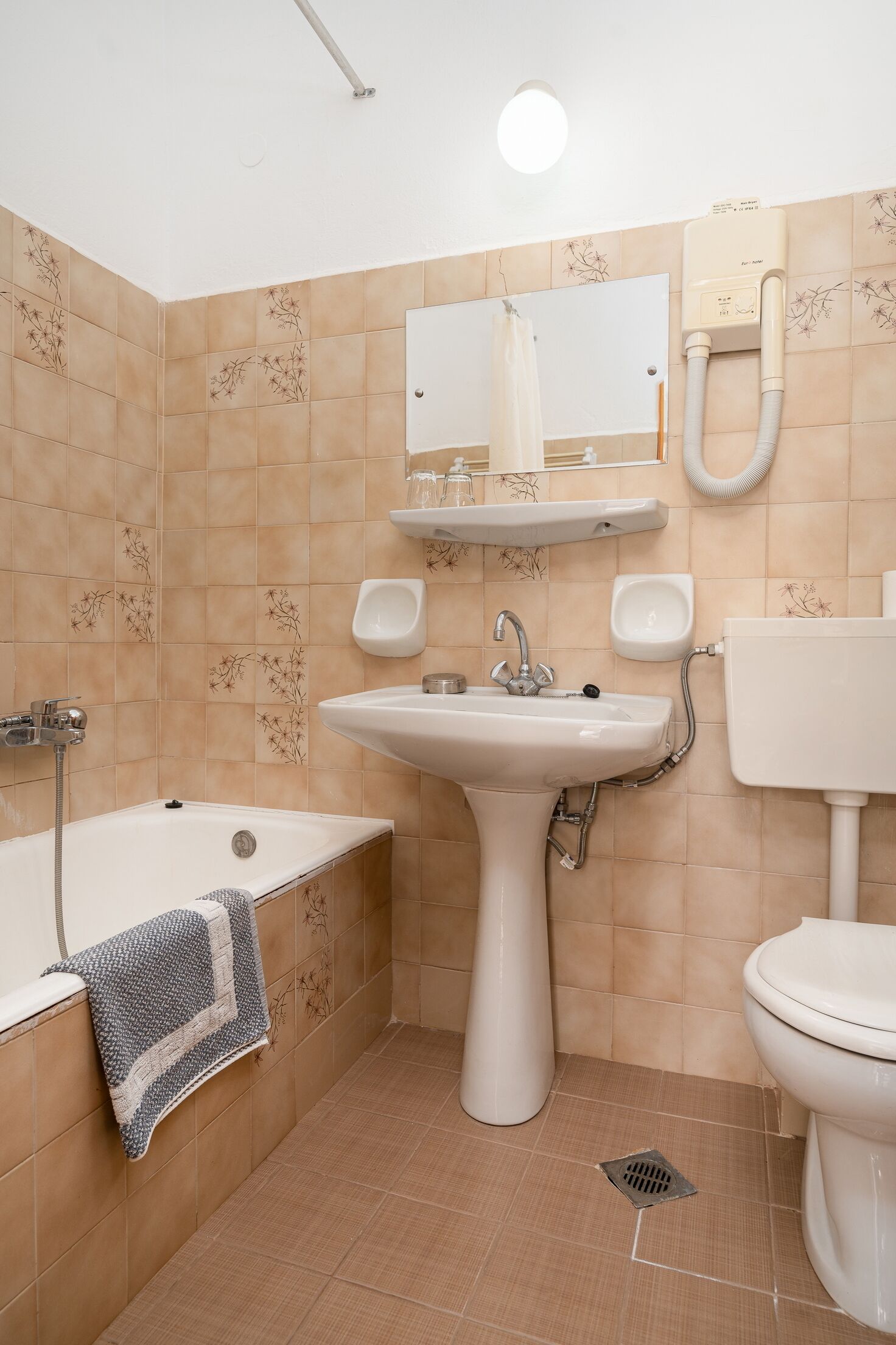 A bathroom with a sink, toilet, and shower.