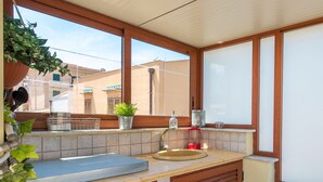 A kitchen with a sink, countertop, and window. - Terrazza dei Colori alla Kalsa by Wonderful Italy (Palermo)
