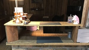 A wooden reception desk with a stone base, a sign reading "MIX ARFALL," and a "Parelli" logo on the floor mat.