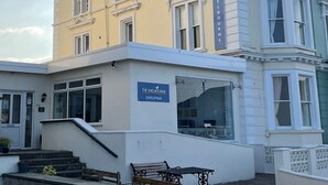 A building with a sign reading "THE SHELBORNE" and a phone number. - The Shelbourne (Llandudno)