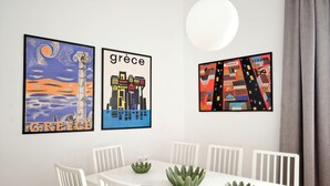 A dining area with a white table and chairs, decorated with succulents. - Art in Athens Suite (Athens)