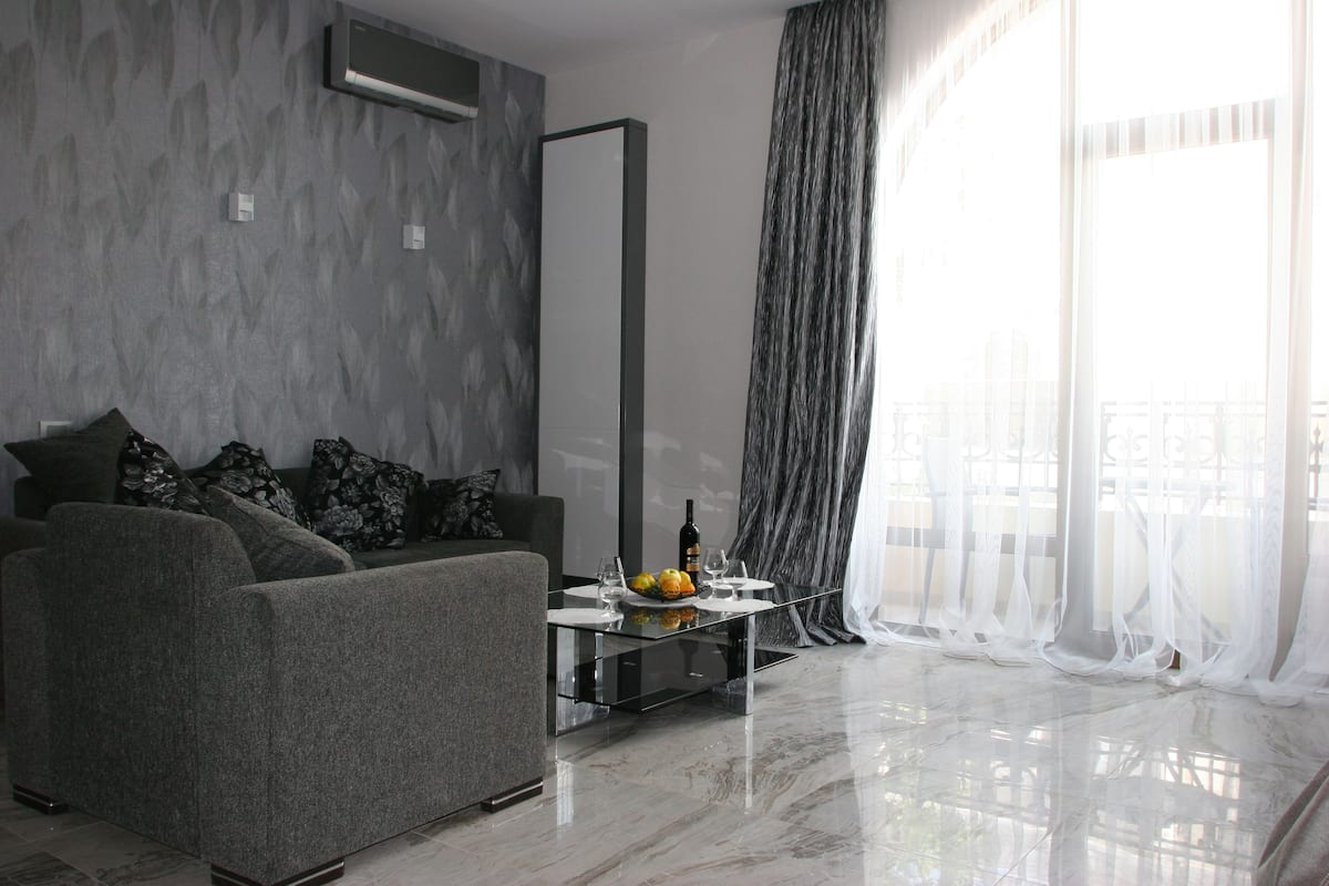 Luxury Studio Suite | Living area | Flat-screen TV