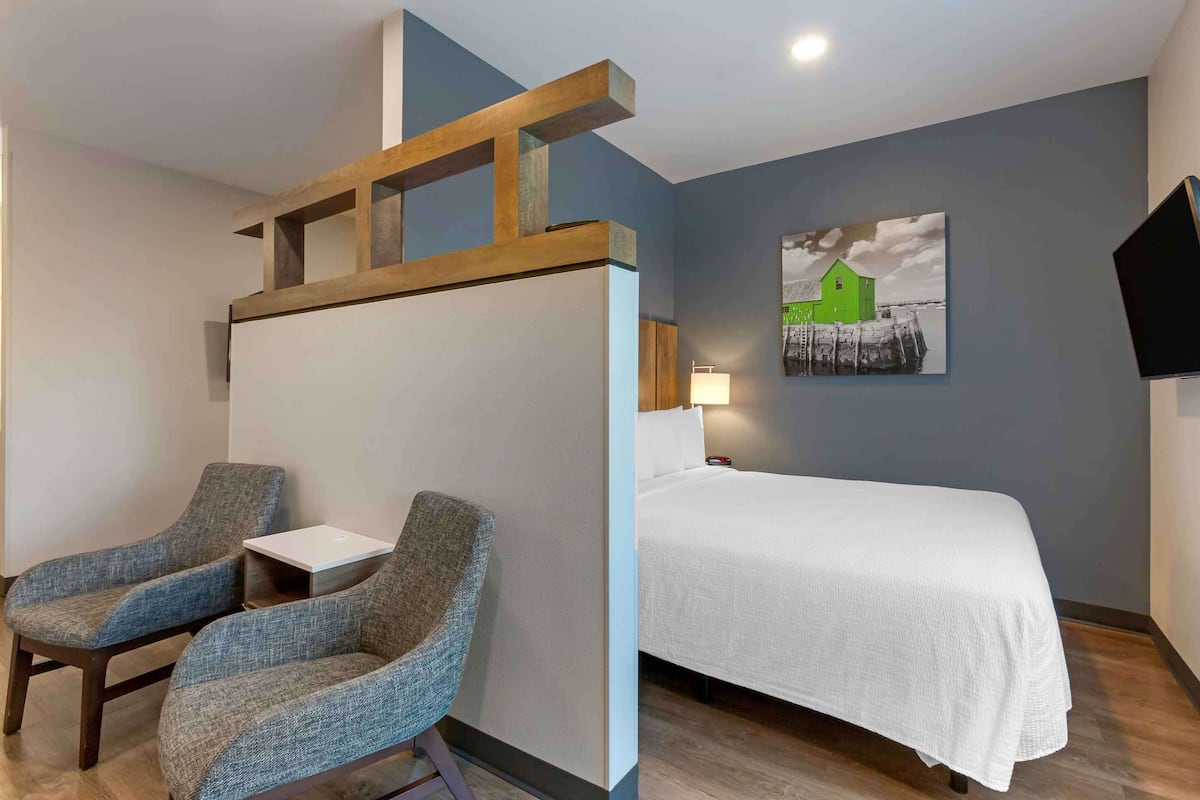 Premium bedding, desk, laptop workspace, iron/ironing board