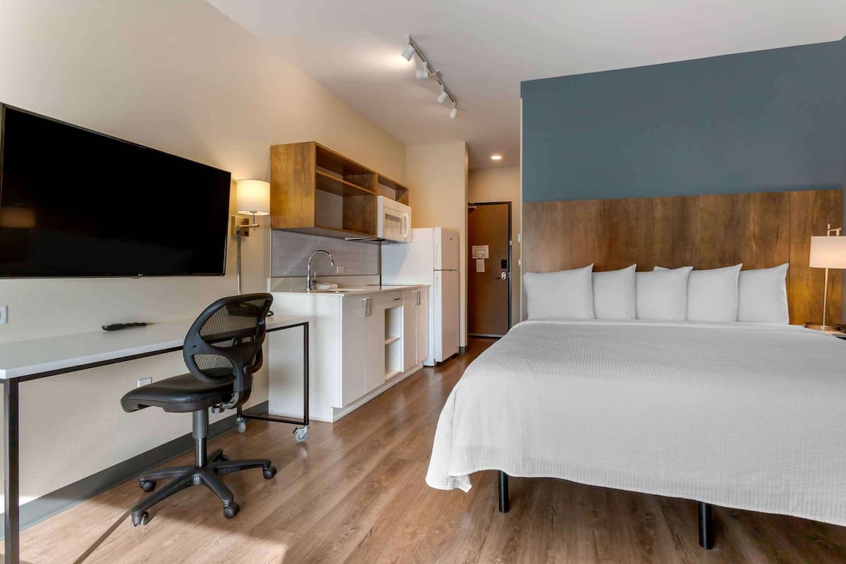 Premium bedding, desk, laptop workspace, iron/ironing board
