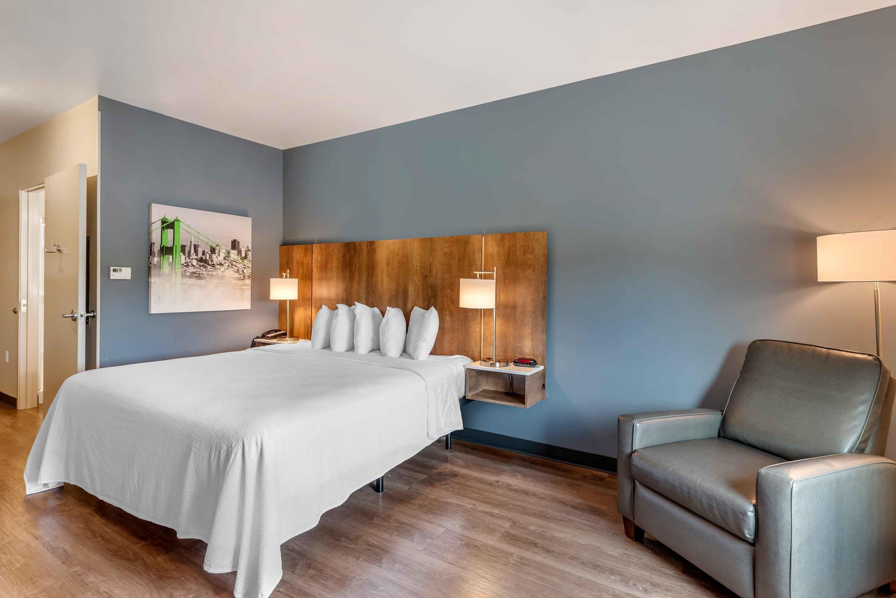Premium bedding, desk, laptop workspace, iron/ironing board