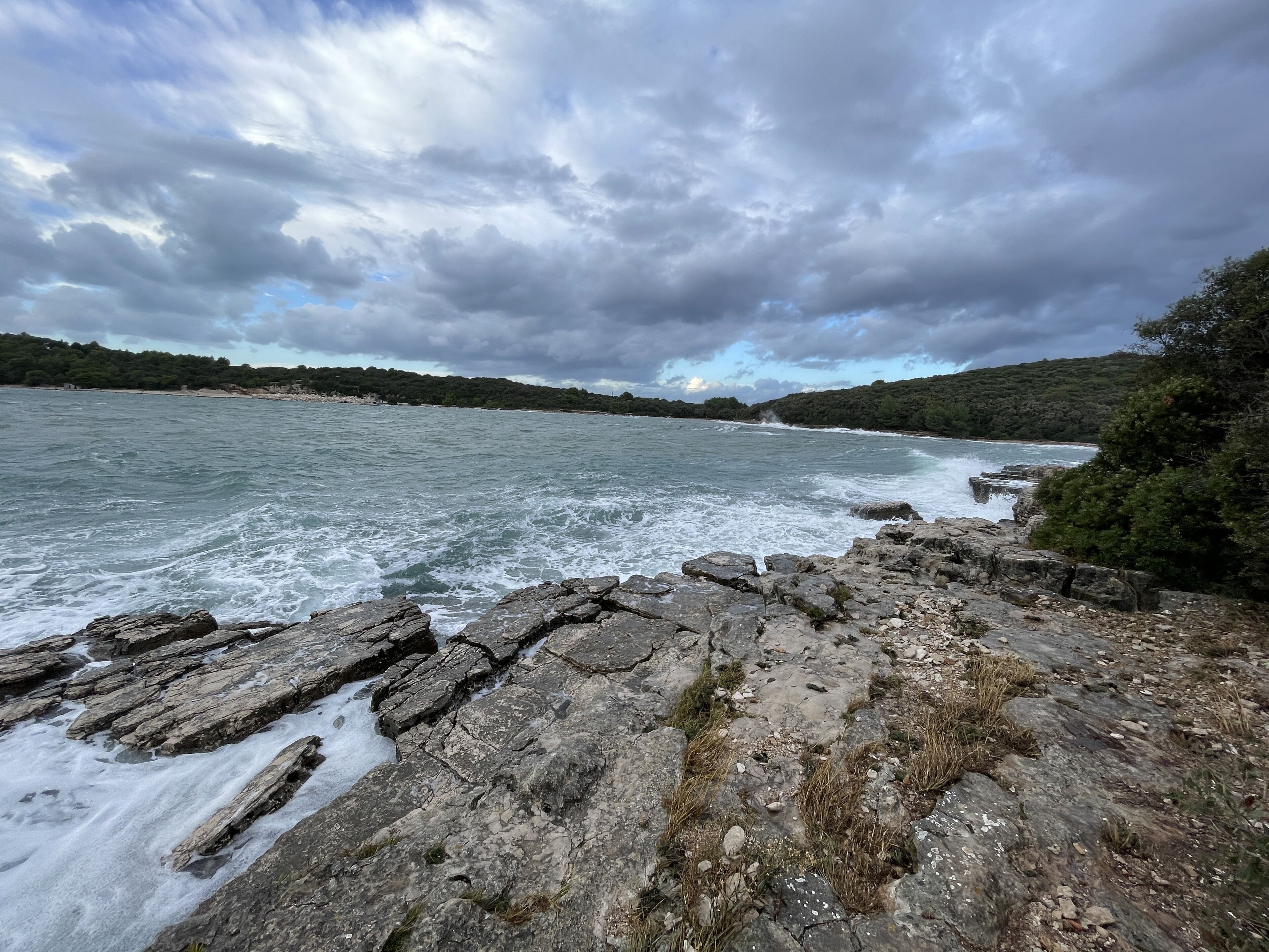 A rocky shoreline with waves crashing against the rocks.