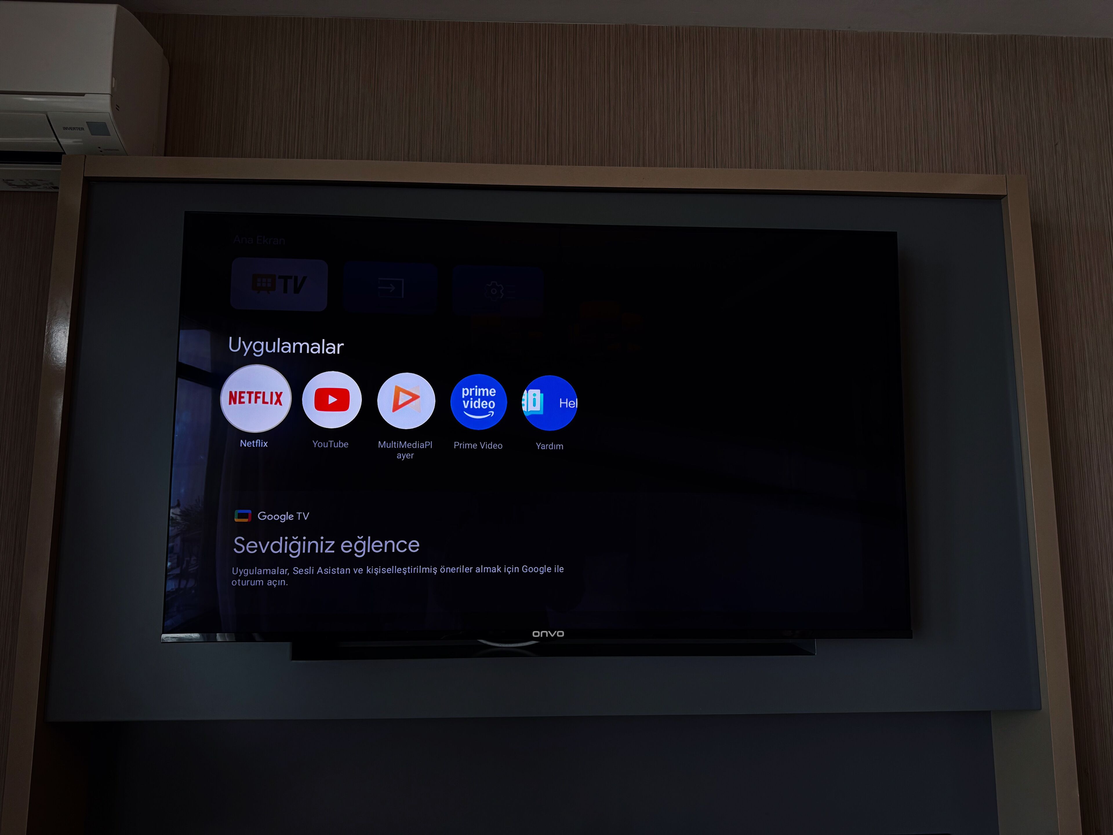 A TV screen displaying a streaming service interface with icons for Netflix, YouTube, MultiMediaPl, Prime Video, and Yardm.