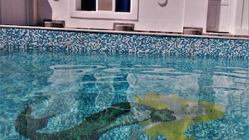 Seasonal outdoor pool, open 10:00 AM to 9:00 PM, pool umbrellas