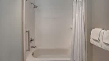 Un baño con bañera, ducha y toallero.