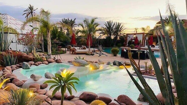 A pool surrounded by rocks and cacti, with lounge chairs and umbrellas in the background. - Eden Lodges & Spa -Boutique Hôtel de Luxe (Marrakech)