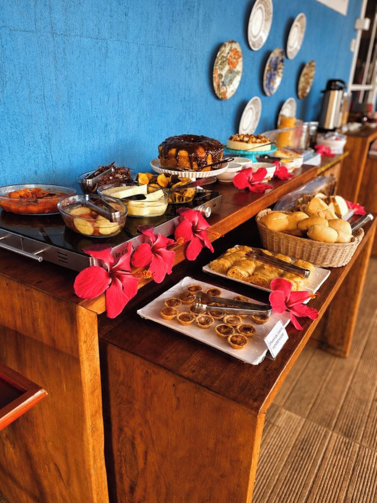 A buffet table with various food items and a coffee station.