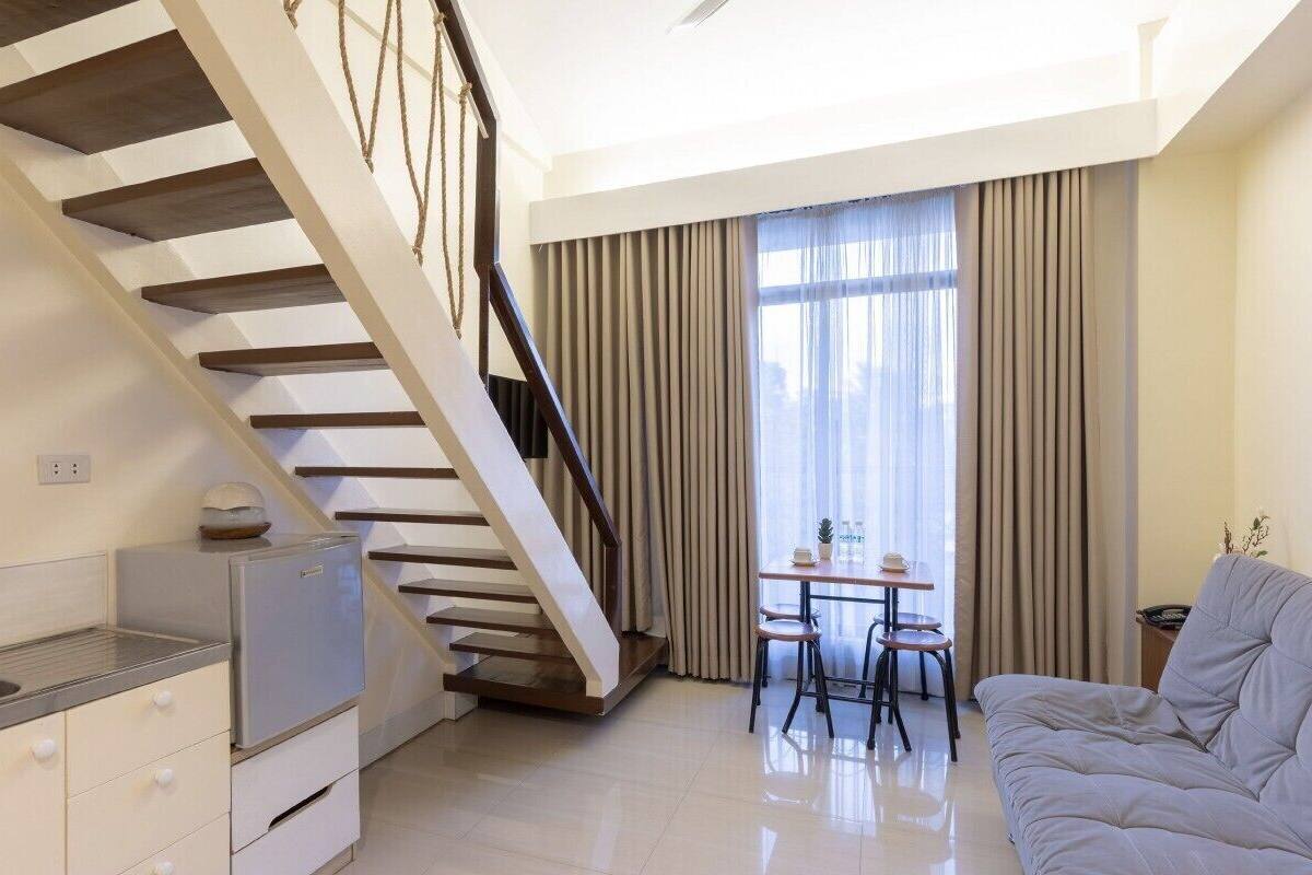 A modern apartment with a kitchen, a dining area, and a living room.