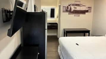 Eenvoudige eenpersoonskamer | Badkamer | Een bad/douchecombinatie, een haardroger, handdoeken