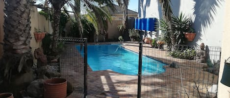 Outdoor pool with safety gate for kids and animals