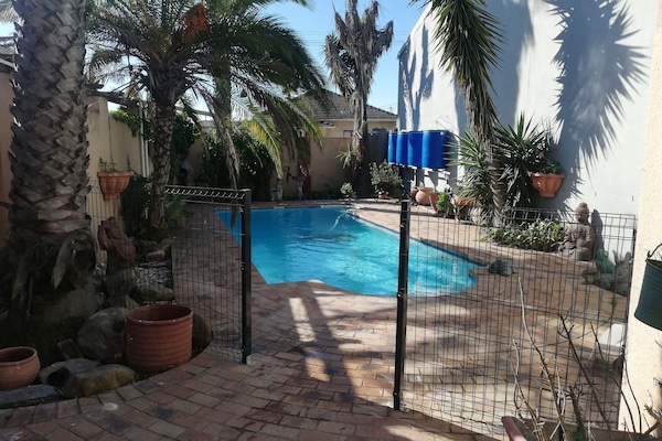 Outdoor pool with safety gate for kids and animals