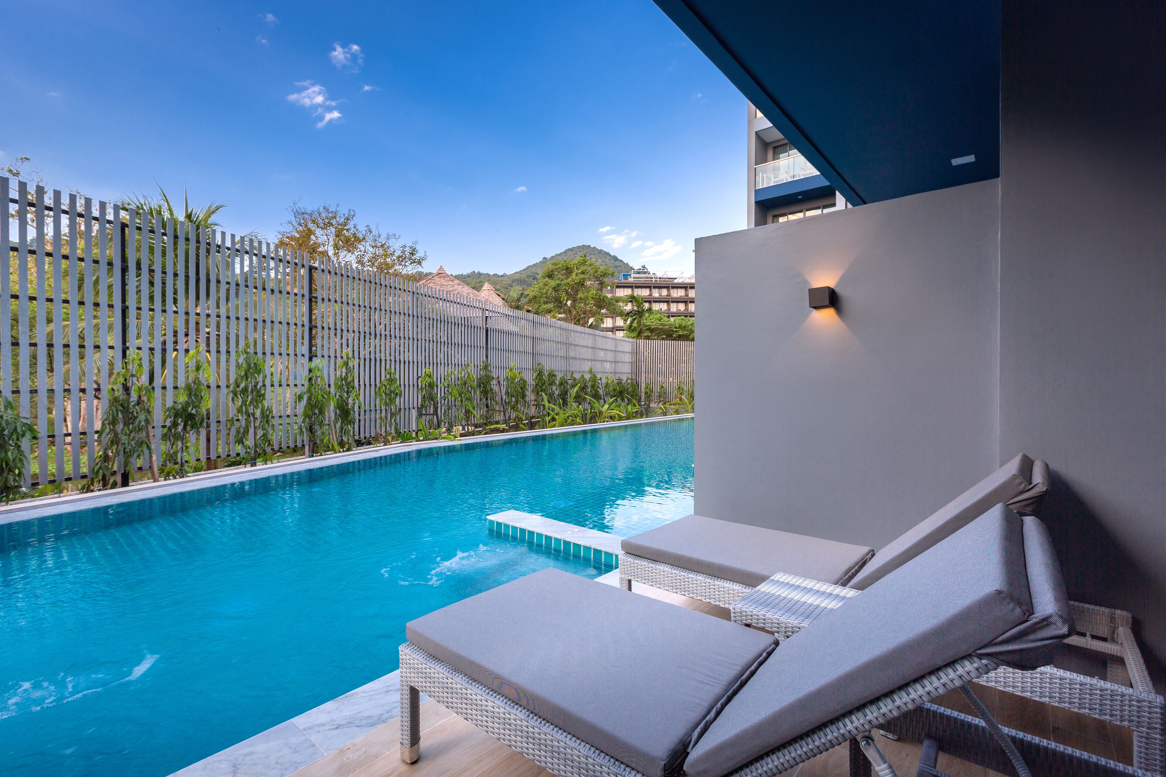 A poolside area with lounge chairs and a clear view of the pool.
