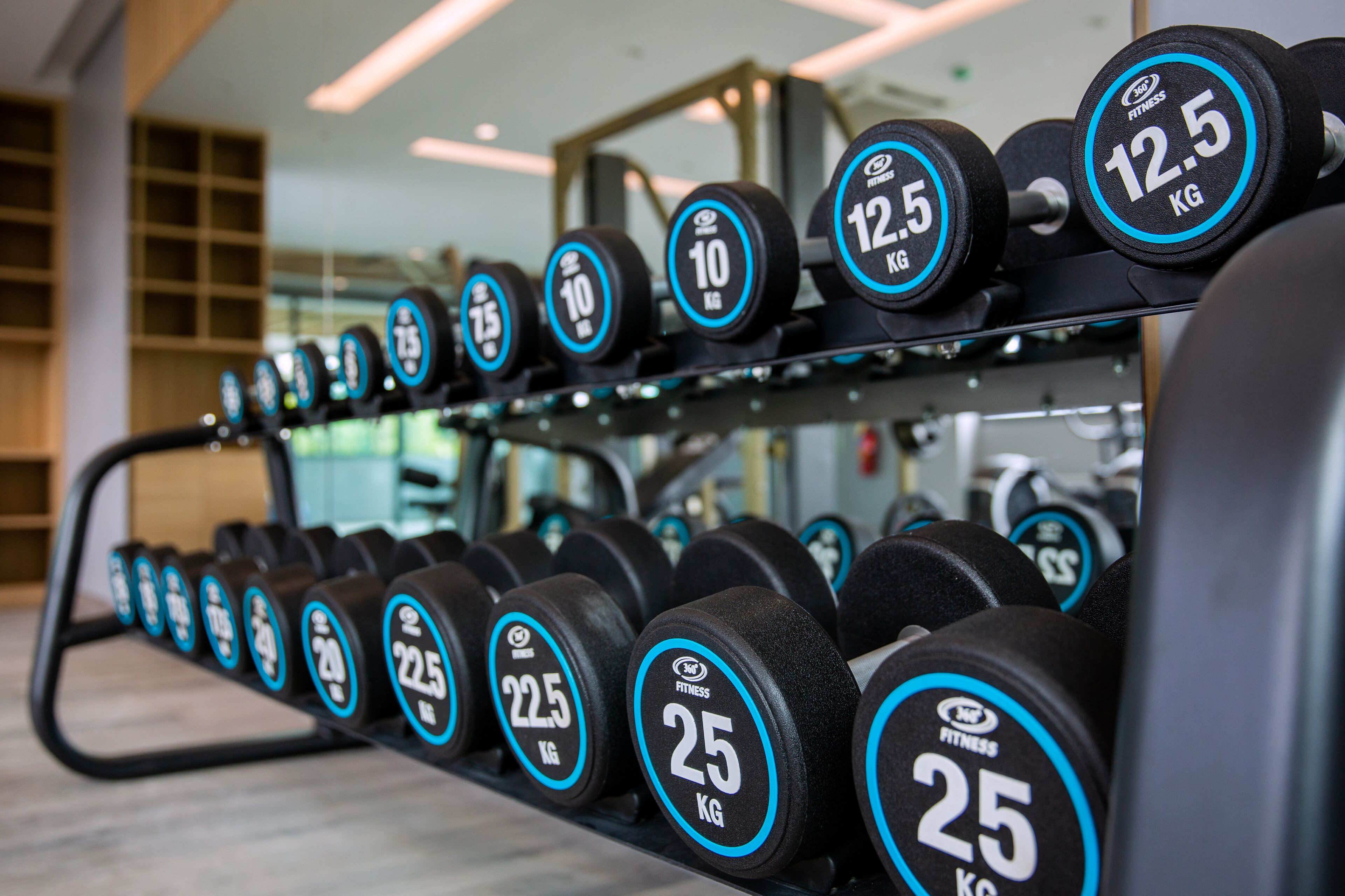 A rack of dumbbells with weights ranging from 10 kg to 25 kg.