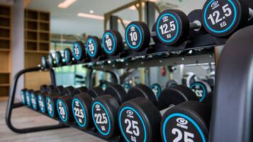A rack of dumbbells with weights ranging from 10 kg to 25 kg.