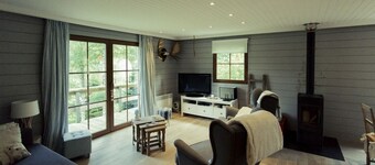 Scandinavian chalet in lush greenery and forest ...