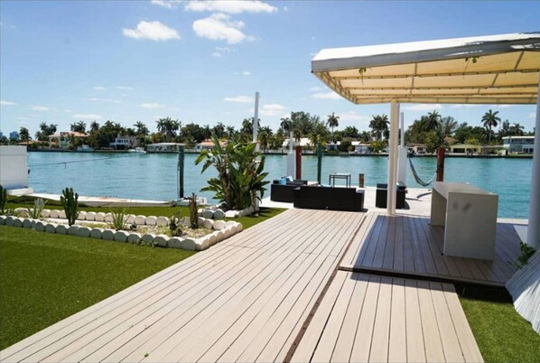 Relax on the deck overlooking the serene water and lush surroundings.