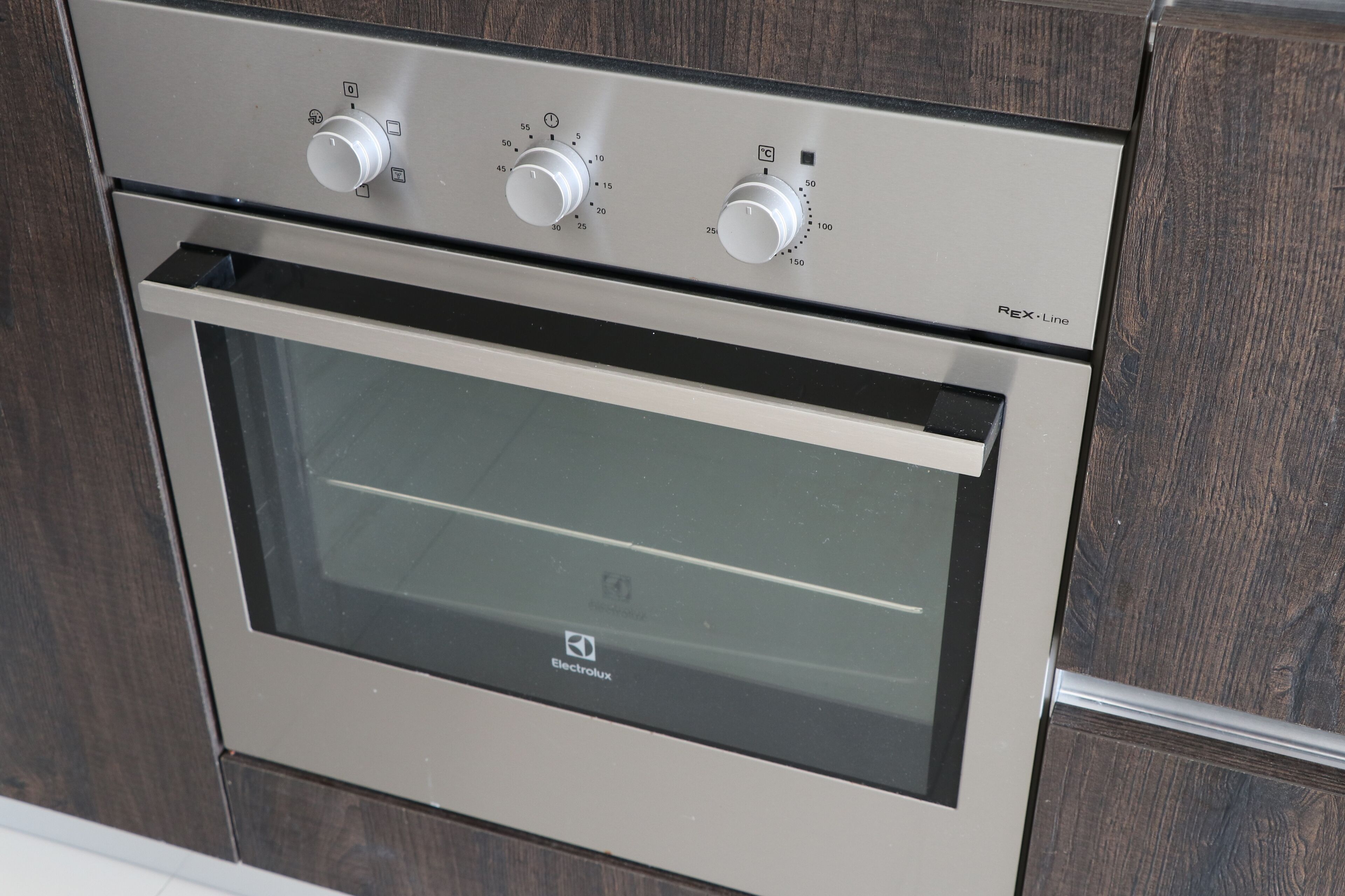 A modern kitchen with a built-in oven and Electrolux branding.
