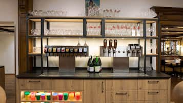 Eine Bar mit Regalen voller Gläser, Flaschen und bunten Bechern.