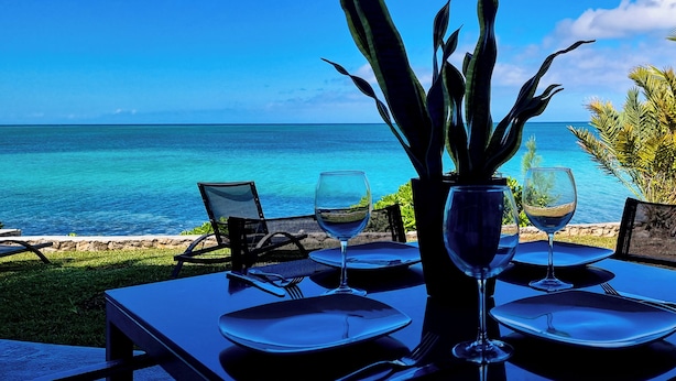 A table set for two with a view of the ocean.