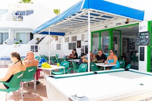 Outdoor dining - Studio , southfacing sea views , own patio, 2 heated pools, overlooking harbour (Puerto del Carmen)