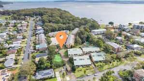 An aerial view of a residential area with a prominent orange location marker. - Bay Parklands, 62 2 Gowrie Avenue - Wifi, Pool, Tennis, Water Views & Aircon (Nelson Bay)