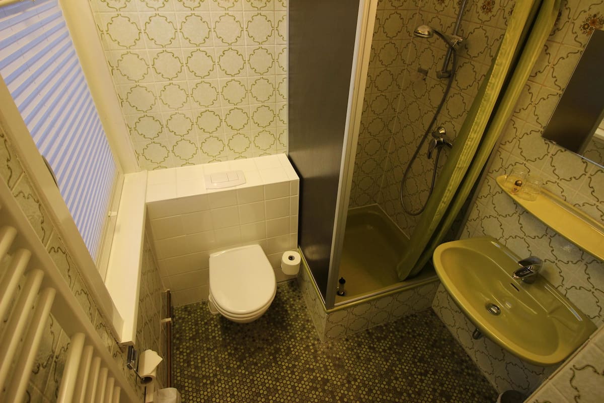 classic single room | bathroom | shower, hair dryer, towels, soap