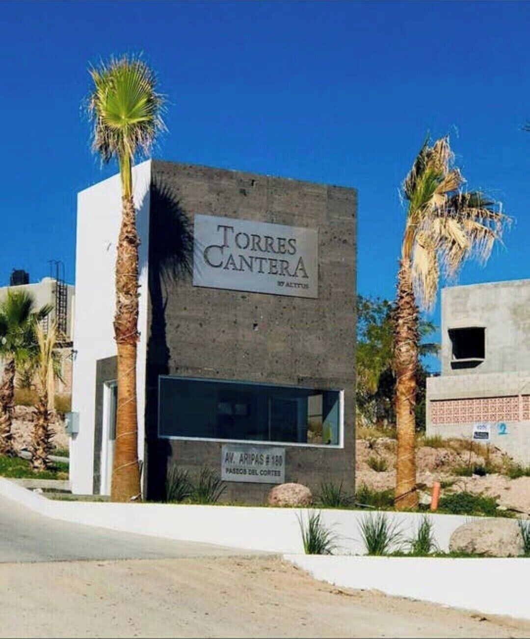 A modern building with a sign reading "Torres Cantera."
