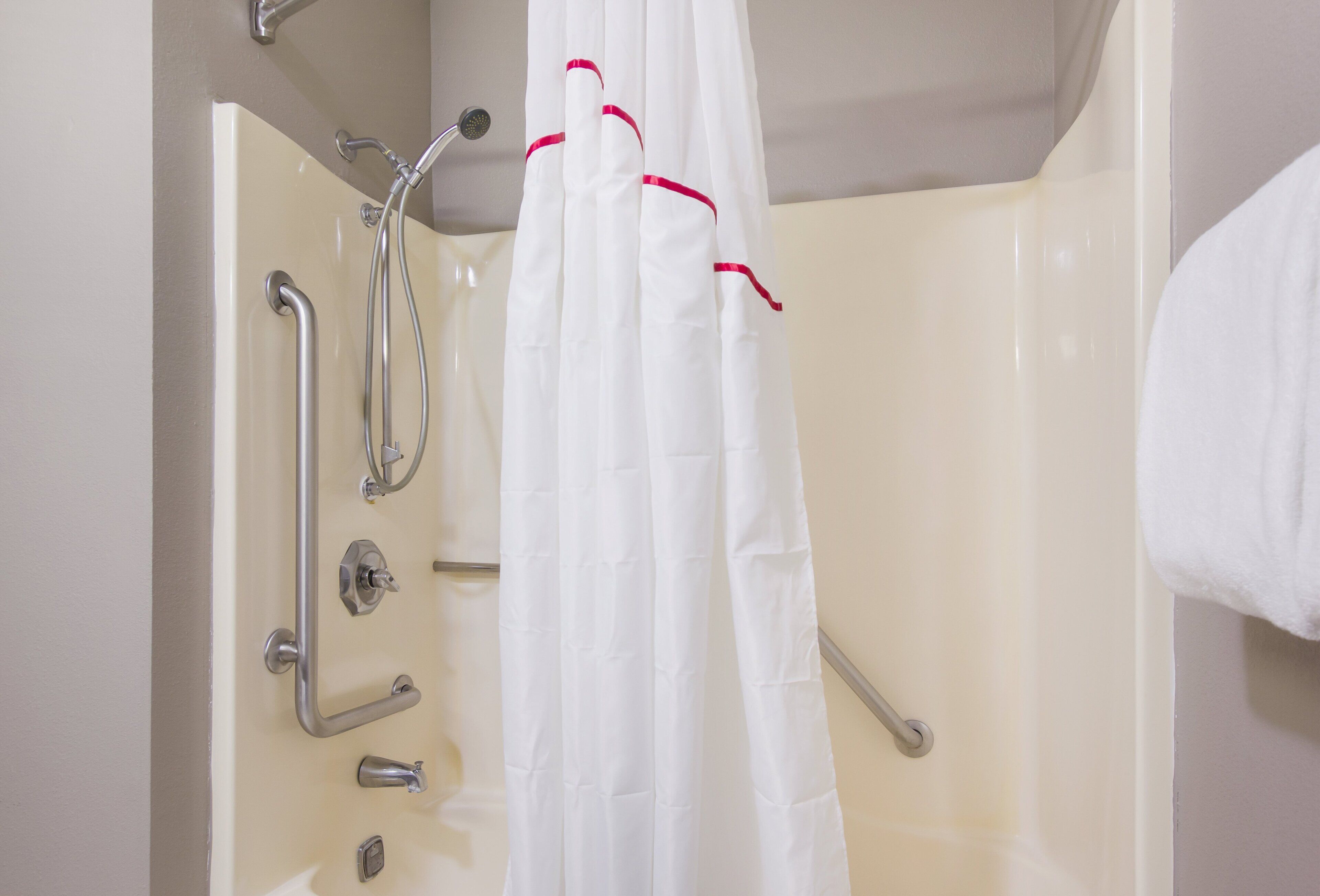 deluxe room, 1 king bed, accessible, non smoking | bathroom | combined shower/bathtub, rainfall showerhead, free toiletries