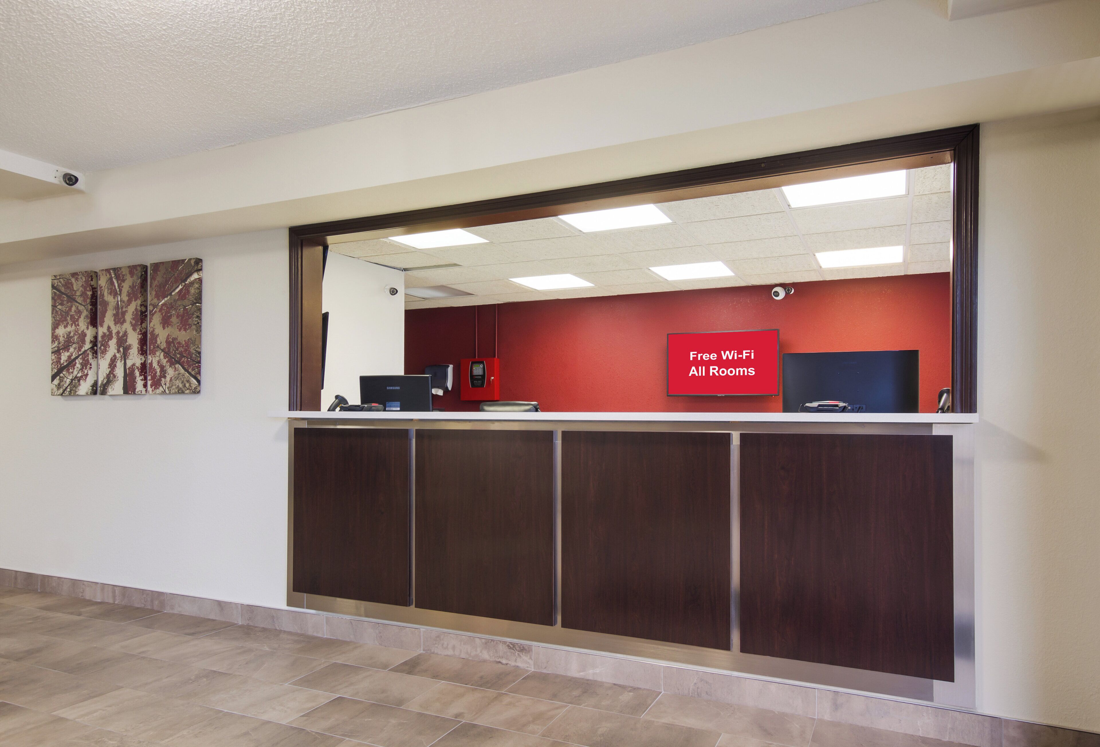 A reception desk with a red sign indicating free Wi-Fi in all rooms.