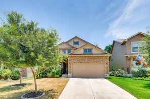 Stunning home with a brick facade, garage, and beautifully manicured lawn.