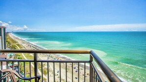 A balcony with a view of a beach and ocean. - 2 BALCONIES/DIRECT OCEANFRONT/PET FRIENDLY/CORNER UNIT/ BEST VIEW/RESTAURANT (Myrtle Beach)