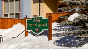 A sign for Crystal Forest, a 6005 Valley Drive establishment. - Perfectly Located beautiful 4 bedroom townhouse (Sun Peaks)