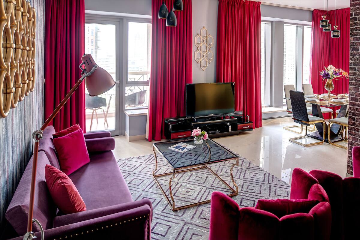 A modern living room with a sofa, a coffee table, and a TV.