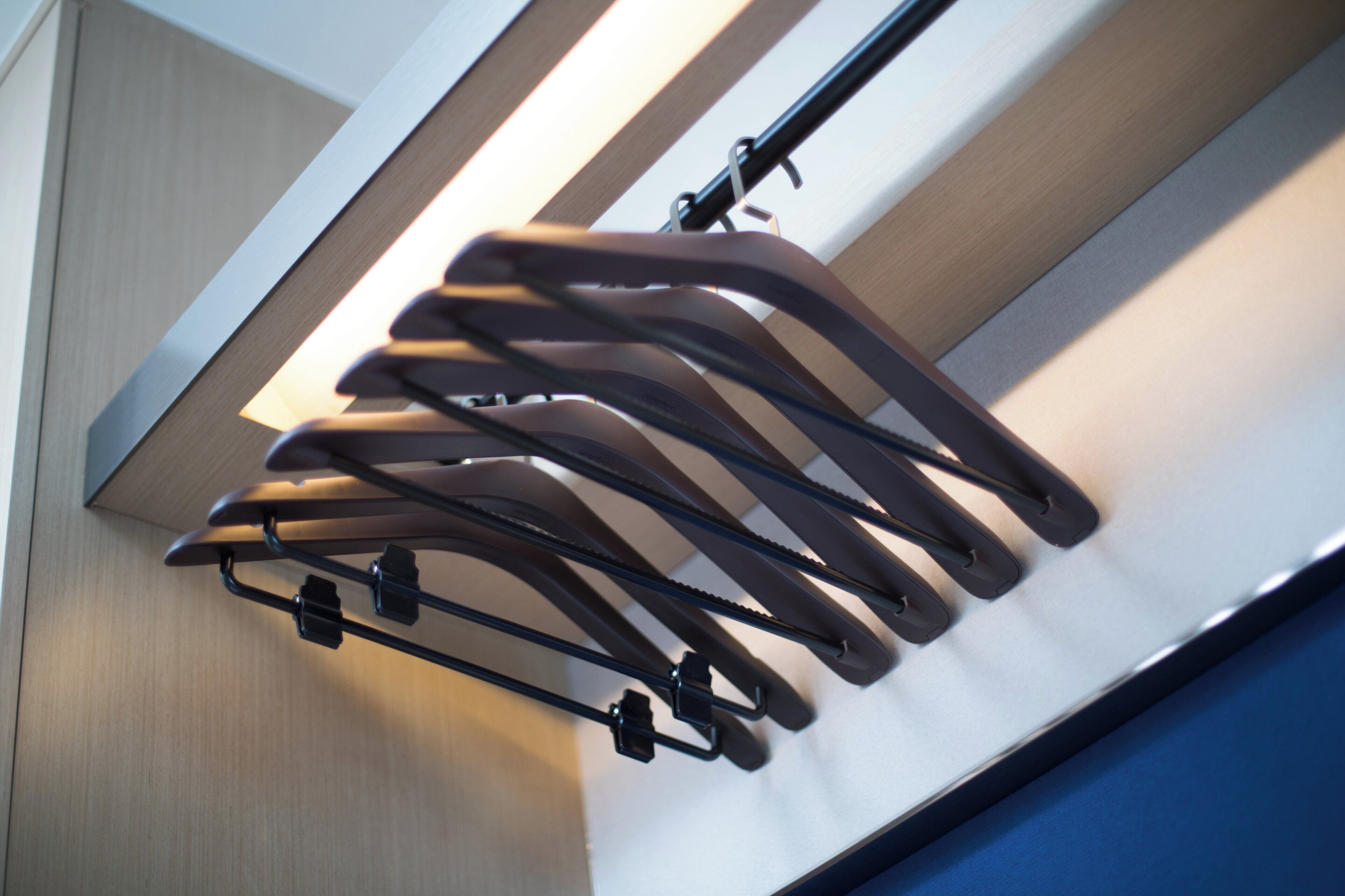A wall-mounted rack with multiple hooks for hanging items.