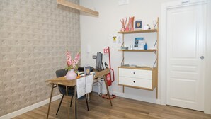 A room with a desk, chair, computer, shelves, and a door labeled "PRIVATE". - Garibaldi Rooms (Naples)