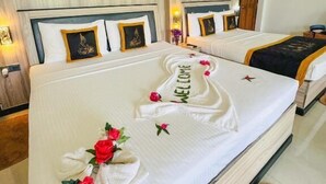 A hotel room with two beds, a wooden headboard, a welcome mat, and a small rug. - Sigiriya Kingdom Resort (Dambulla)