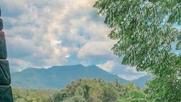 A dining table with breakfast items and a view of a mountain and pool. - Sigiriya Kingdom Resort (Dambulla)