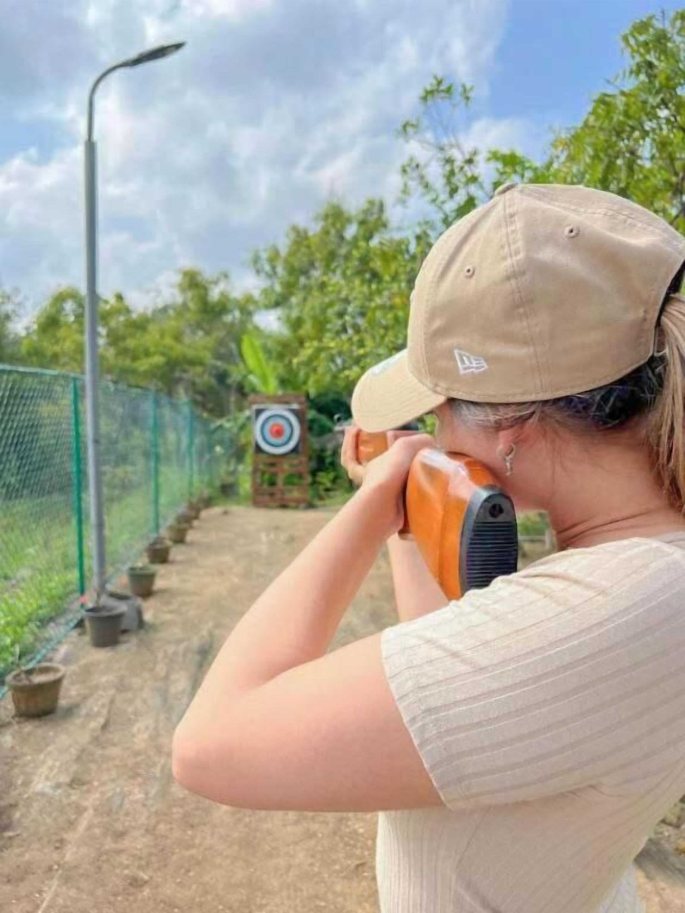 A person aiming at a target with a slingshot.