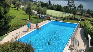 A swimming pool with a view of a lake and mountains. - Como Lake view from olive garden, balcony and pool (Tremezzina)